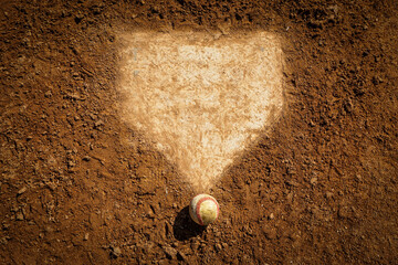 Baseball near home plate on infield dirt