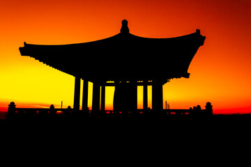 Beautiful traditional Korean design temple, gazebo, silhouette structure in the park at sunset 
