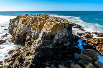 Waves hitting on the cliff at the beach in the morning