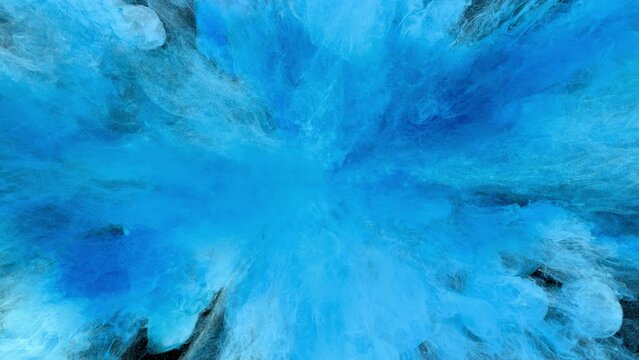 Color Burst - Colorful light blue smoke powder explosion close up. Coloured fluid ink particles in slow motion. Isolated on black background. Alpha matte 4k.