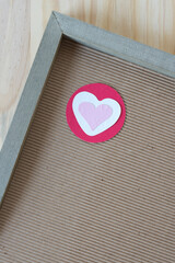 wood frame with isolated paper heart on a circle