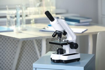 Modern medical microscope on drawer in laboratory, space for text