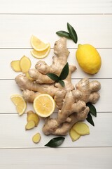 Fresh lemons and ginger on white wooden table, flat lay