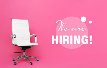 Office chair and text WE`RE HIRING on pink background