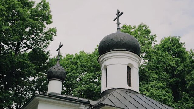 The towers of the church with Orthodox crosses on top. Smooth shooting of a religious building