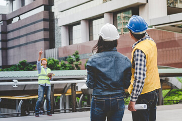 Civil engineer teams meeting working together wear worker helmets hardhat on construction site in modern city. Foreman industry project manager engineer teamwork. Asian industry professional team