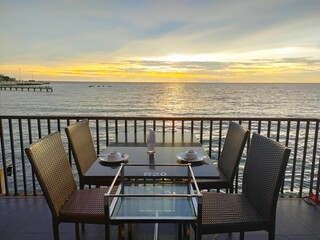 Fototapeta na wymiar Thai restaurant at sunset reserved for customer dinner on the beach in Thailand