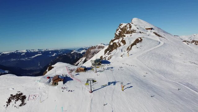 Grindelwald, Switzerland: Aerial drone footage of ski chair lifts in the Jungfrau region ski resort at the Kleine Scheidegg in the Berner Oberland alps near Interlaken on a sunny winter day