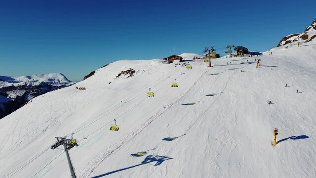 Grindelwald, Switzerland: Aerial drone footage of ski chair lifts in the Jungfrau region ski resort at the Kleine Scheidegg in the Berner Oberland alps near Interlaken on a sunny winter day