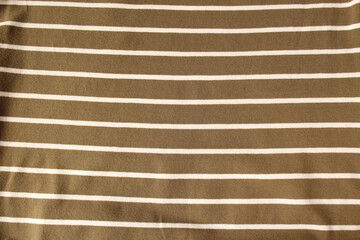 Green ocher crumpled fabric linen with white stripe for creative background. Copy space. Natural...
