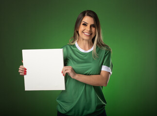 woman soccer fan cheering for her favorite club and team. world cup green background. Holding White Blank Card.
