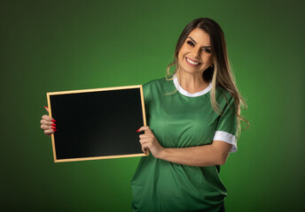 woman soccer fan cheering for her favorite club and team. world cup green background. Holding a blackboard.