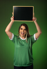 woman soccer fan cheering for her favorite club and team. world cup green background. Holding a blackboard.