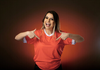 woman soccer fan cheering for her favorite club and team. world cup orange background