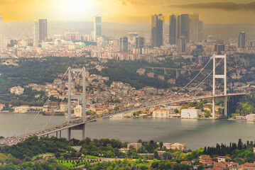 Fototapeta na wymiar Sunset aerial shot of Istanbul city from Camlica park overlooking Bosphorus strait, with Bosphorus Bridge, or Bogazici Koprusu, connecting Europe and Asia, suited in Istanbul, Turkey
