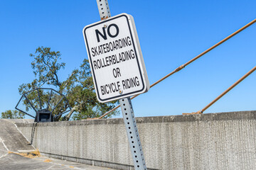 No Skateboarding, Rollerblading, or Bicycle Riding Sign on Top of the Armored Levee along Lake...