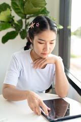 woman using tablet computer in cafe