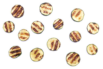Slices of zucchini roasted on a grill with stripes from a grill isolated on white background