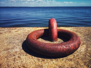 rusty metal mooring ring on concrete pier, Lithuania - 534877733