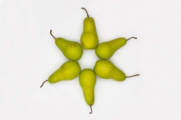 Star of David made from pears on white background. Ripe pears laid out in the shape of an eight-pointed Star of David - a symbol of Jewish identity Judaism.  Sweet and juicy pears. Close-up. Top view