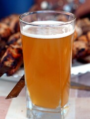 A glass of cold beer on the background of homemade freshly prepared kebab on skewers. Natural food.Photo of food.