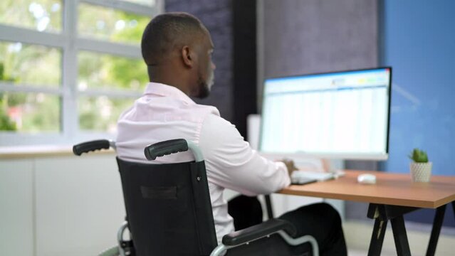 Happy Man With Disability Using Computer