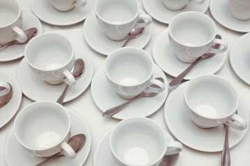 Obraz na płótnie Canvas White tea cups with spoons