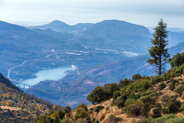 Panoramic view of the south from the peaks of the Sierra Nevada, with the Rules reservoir, the viaduct, the town of Velez de Benaudalla and the Mediterranean in the background.