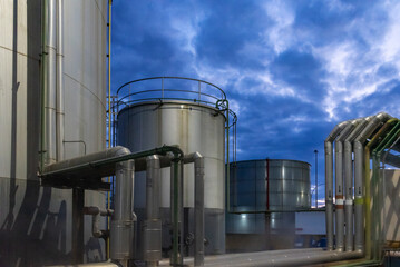 Large tanks and pipes that connect them in a cogeneration plant that uses fuel oil to produce electricity.