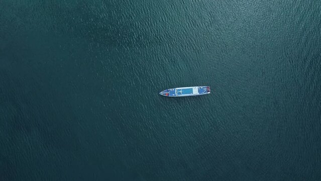 4k Aerial view of research vessel ship moves through blue waters outdoors irrl. Top pic of long boat sailing on turquoise waters and traveling during outdoor summertime. Creative tourist filming