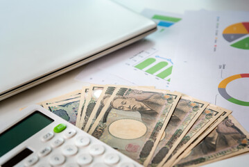 Japanese yen banknote on work space office table for currency, bugget, business finance concept.