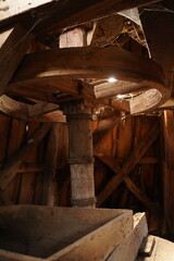 Fototapeta na wymiar Huge wooden antique mill mechanism from the inside