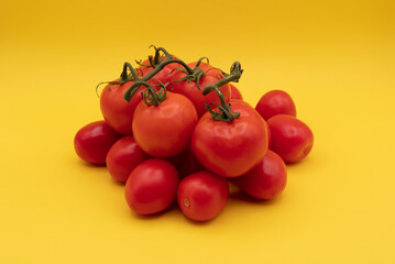 Fresh red Tomatoes on a Yellow Background