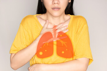Asian beautiful woman sitting in living room are cough and using hand touch her chest . Healthcare...