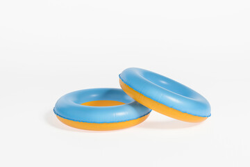 Two swimming rings on empty white background, copy space