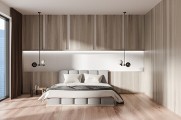 Stylish bedroom interior with bed and nightstand, panoramic window