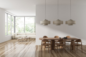 Light living room interior with dining and relaxing area, panoramic window