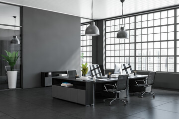 Grey office interior with pc computer, desk and panoramic window. Copy space