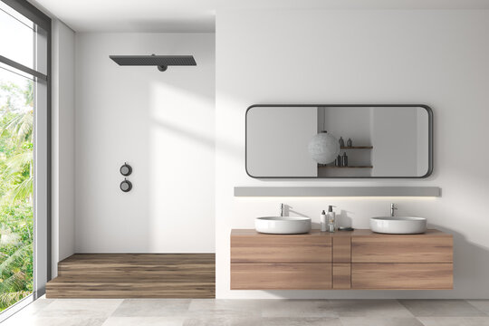 Light bathroom interior with double sink and douche, panoramic window