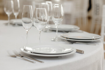 Served dinner table in a restaurant. Restaurant interior, table setting for a dinner, table set for a dinner.