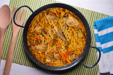 Paella with noodles, rabbit and vegetables. Tapa typical of the Spanish coast.