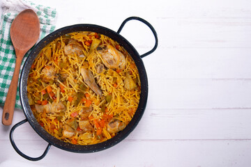 Paella with noodles, rabbit and vegetables. Tapa typical of the Spanish coast.