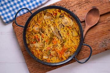 Paella with noodles, rabbit and vegetables. Tapa typical of the Spanish coast.