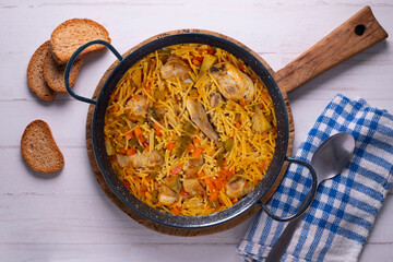 Paella with noodles, rabbit and vegetables. Tapa typical of the Spanish coast.