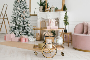 Fototapeta na wymiar Transfer cart with Christmas decor and gifts in the interior of a classic living room