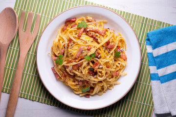 Spaghetti a la cardinale. Pasta cooked with cream and bacon. Traditional Italian recipe.