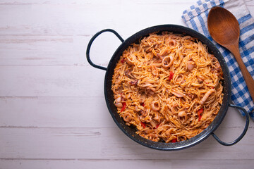 Paella with noodles, squid and seafood. Tapa typical of the Spanish coast.