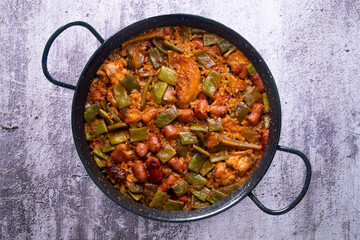 Paella with green beans and sausages. Typical Spanish paella tapa recipe with meat.