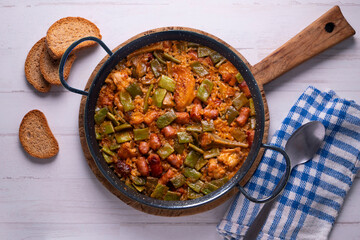 Paella with green beans and sausages. Typical Spanish paella tapa recipe with meat.