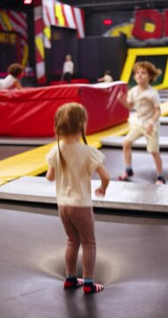 excited kds having fun at the entertainment center, bouncing on the trampoline
